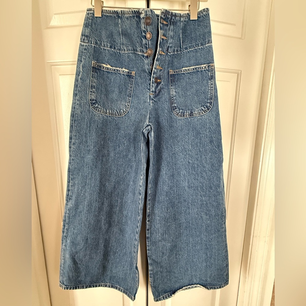 Free People cropped jeans with front pockets and cinched waist.